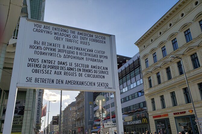 Berlin: Private Highlights Walking Tour with Local Guide and Hotel pickup - Stop 1: Brandenburg Gate as a Living Symbol of Reunification